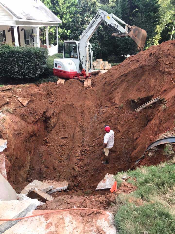 SINK HOLE CLEAN OUT AND RETAINING WALL